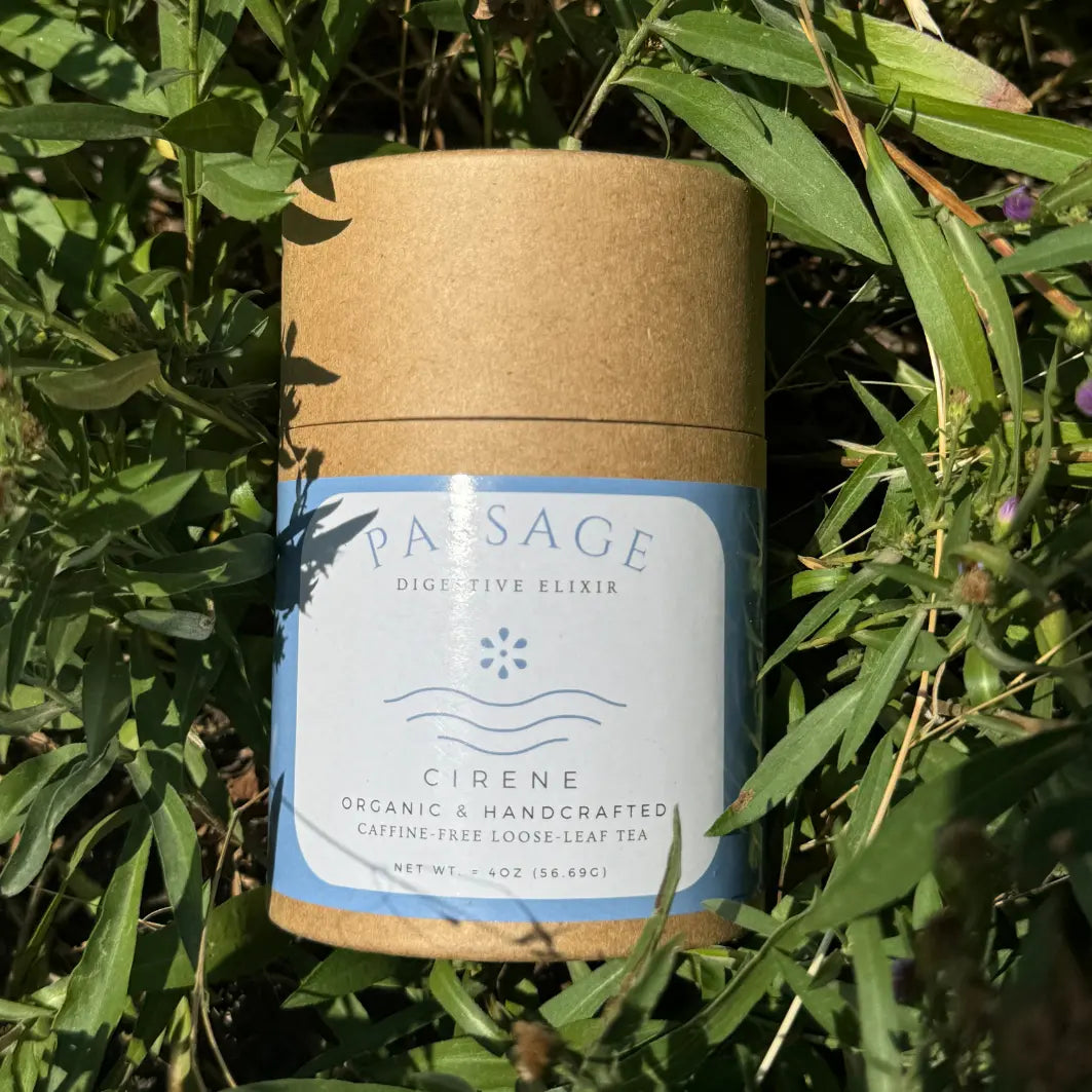 Passage by CIRENE is an organic, handcrafted, caffeine-free loose leaf tea designed to support digestion. Packaged in an eco-friendly container with minimalist blue and white labels, this tea blend embodies wellness and natural purity.